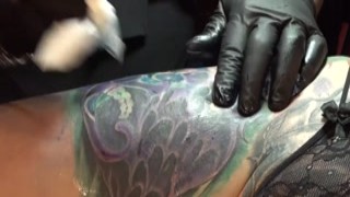 Marie masturbates while being tattooed